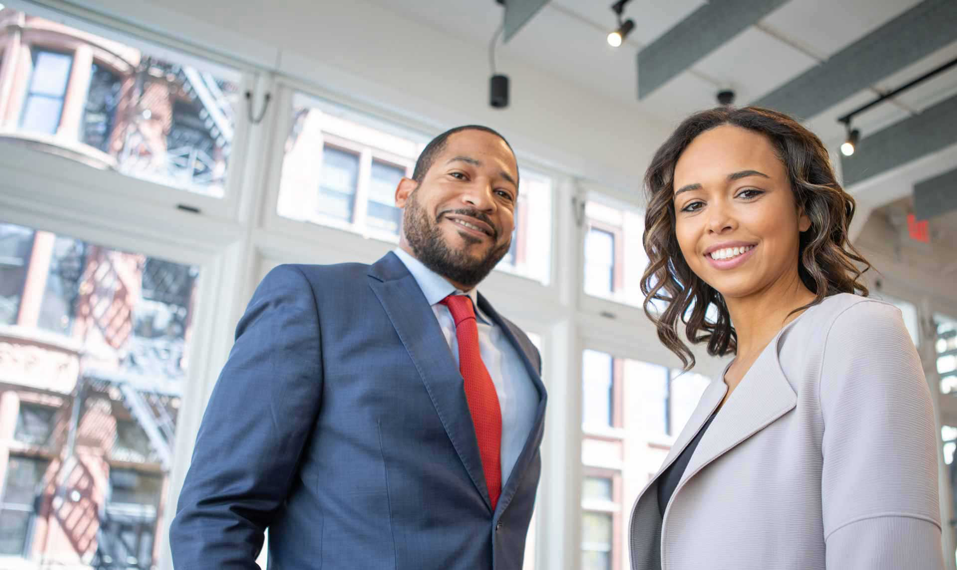Two Jays Financials advisors smiling in a bright office